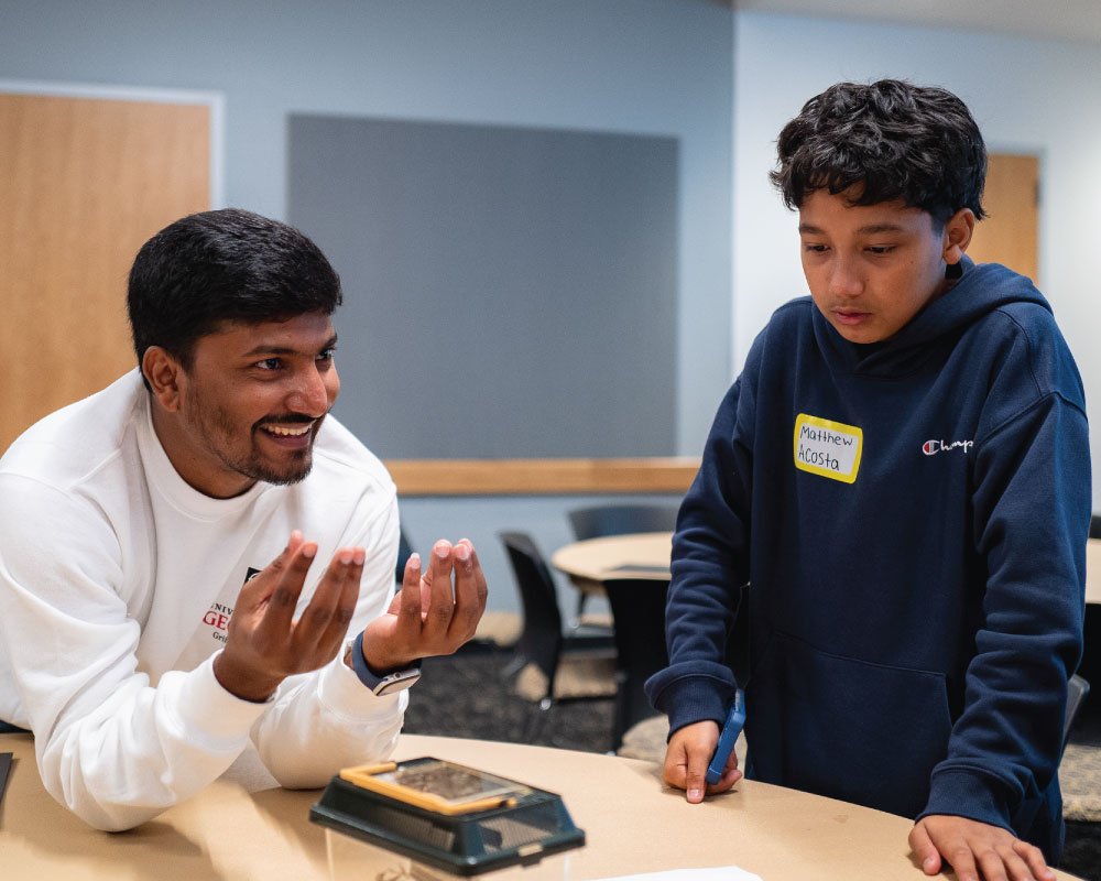 smiling instructor with student