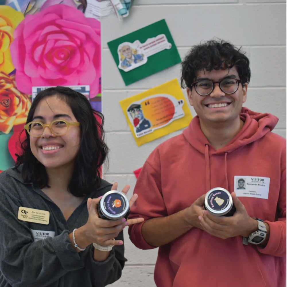 two smiling adults holding jars